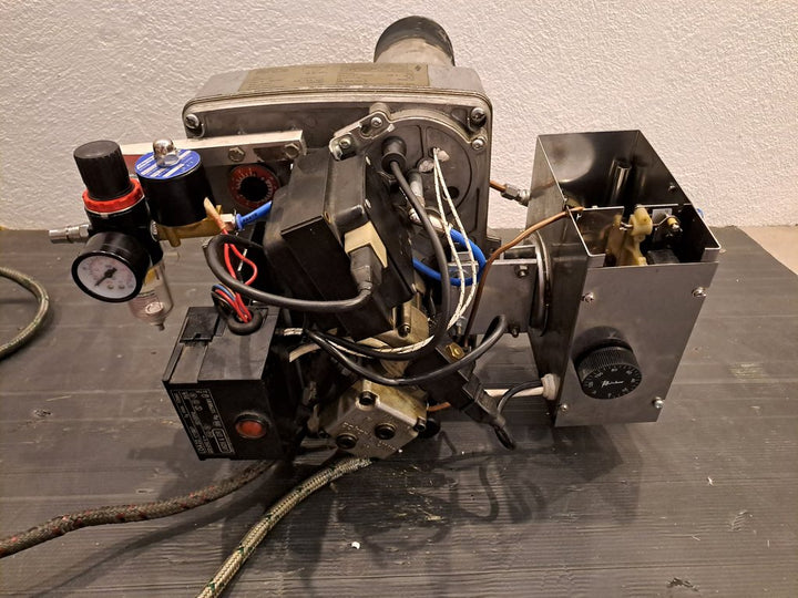 Zum Universalölbrenner umgebauter Heizölbrenner von hinten: links die Drucklufteinheit mit Manometer und Magnetventil, rechts der Vorheizbehälter mit Thermostat-Drehknopf
